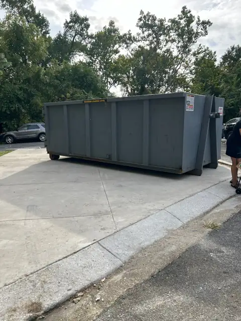 Gray roll off container on a concrete apron in Germantown, MD